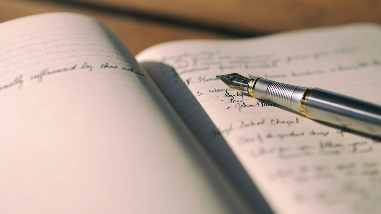 photo of a journal and a pen